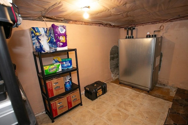 finished below grade area featuring freestanding refrigerator