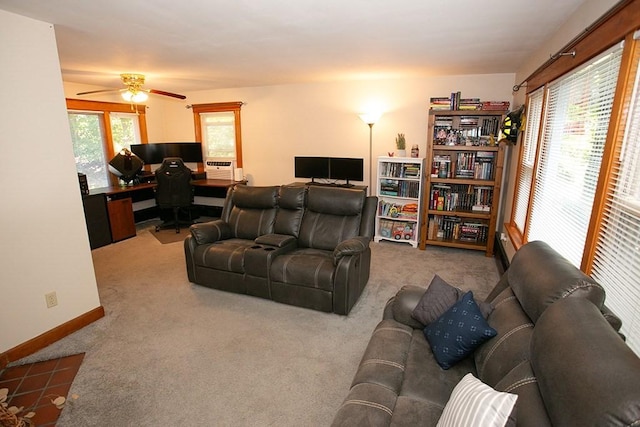 living room featuring an office area, carpet floors, a ceiling fan, and baseboards