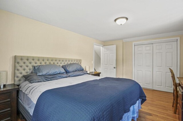bedroom with a closet and wood finished floors