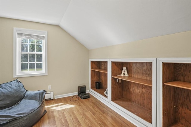 sitting room with baseboard heating, baseboards, wood finished floors, and lofted ceiling