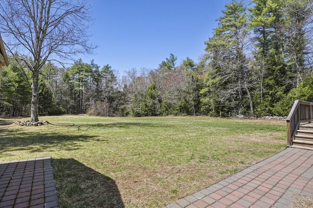 view of yard with a view of trees