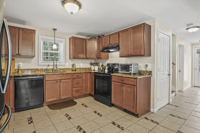 kitchen featuring dark stone counters, a sink, under cabinet range hood, black appliances, and a toaster