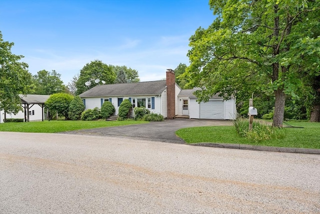 18 Fairview Rd, Westborough, MA 01581 - view of front of property with asphalt driveway, an attached garage, a chimney, and a front yard