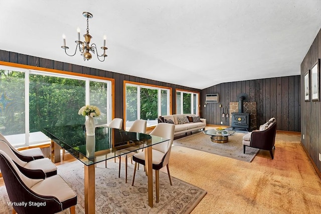 18 Fairview Rd, Westborough, MA 01581 - dining room with a wood stove, wooden walls, a chandelier, an AC wall unit, and vaulted ceiling