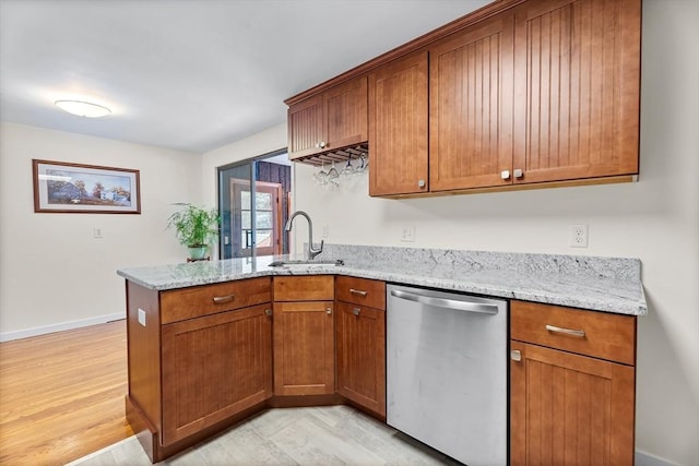 18 Fairview Rd, Westborough, MA 01581 - kitchen with dishwasher, a peninsula, brown cabinetry, and light stone countertops