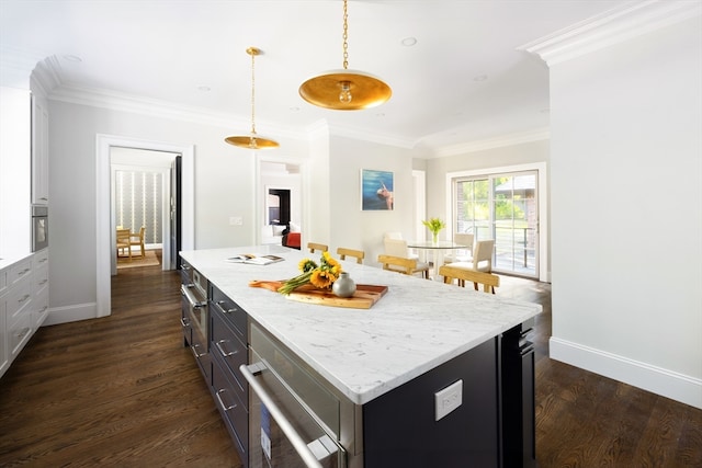 kitchen with decorative light fixtures, crown molding, dark hardwood / wood-style flooring, and a kitchen island