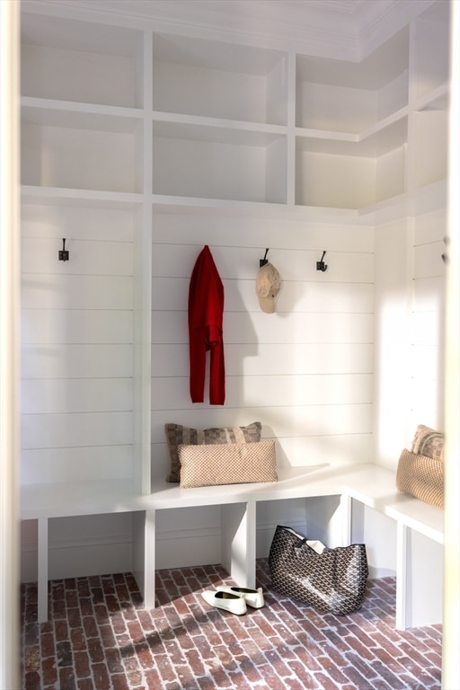 mudroom with wood walls