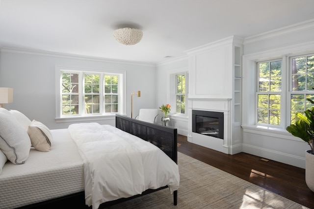 bedroom featuring ornamental molding and dark hardwood / wood-style flooring