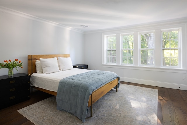 bedroom featuring multiple windows, ornamental molding, and dark hardwood / wood-style floors