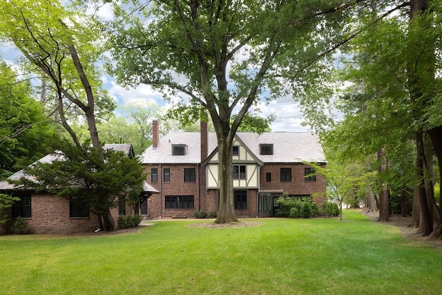 back of house with a lawn