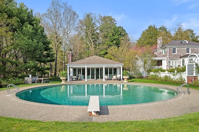 view of pool featuring a patio and a diving board