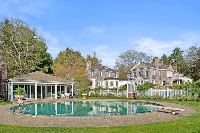 back of house with a patio and a fenced in pool