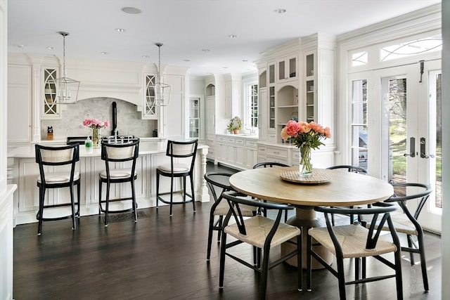 dining space with dark hardwood / wood-style floors and a healthy amount of sunlight