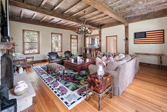 living room with beamed ceiling, a chandelier, light hardwood / wood-style floors, and wood ceiling