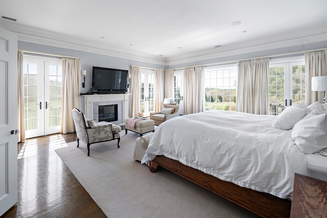 bedroom with hardwood / wood-style floors, access to exterior, ornamental molding, and french doors