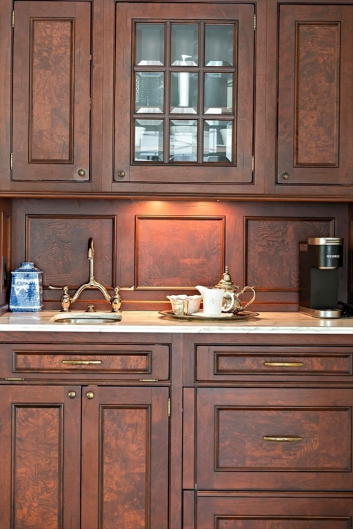 kitchen featuring sink and dark brown cabinets