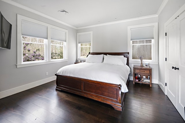 bedroom with a closet, ornamental molding, and dark hardwood / wood-style flooring