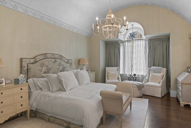 bedroom featuring lofted ceiling, hardwood / wood-style flooring, and a chandelier