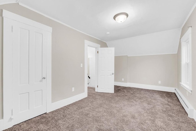 unfurnished bedroom featuring carpet flooring, ornamental molding, vaulted ceiling, and a baseboard heating unit