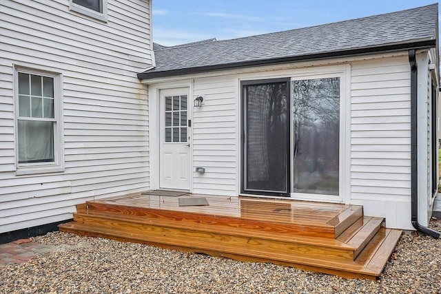 view of exterior entry with a wooden deck