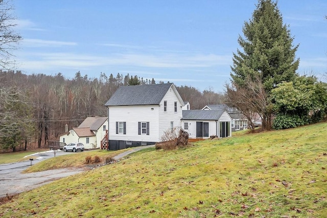 view of side of property with a lawn