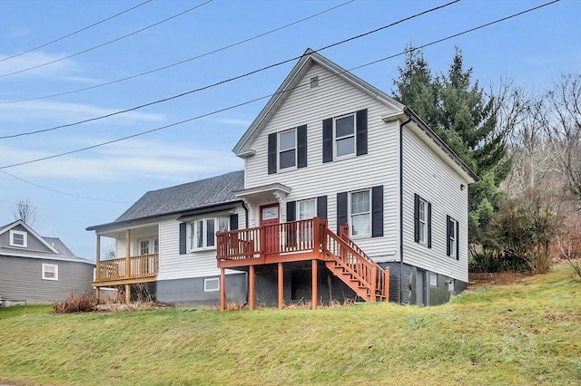 rear view of property featuring a yard and a deck