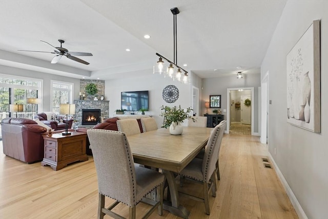 dining area featuring a fireplace, recessed lighting, visible vents, light wood-style flooring, and baseboards