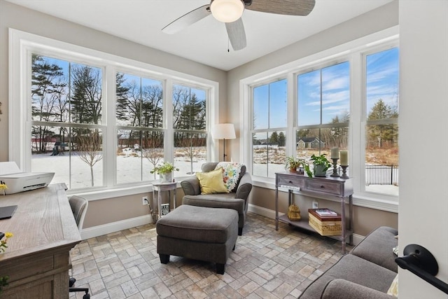 sunroom featuring a wealth of natural light and a ceiling fan