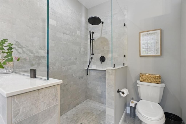 bathroom featuring toilet, baseboards, and a walk in shower