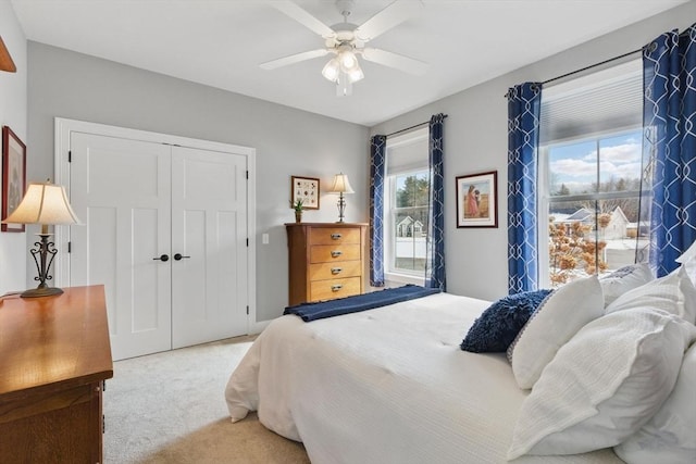 carpeted bedroom with a closet and a ceiling fan