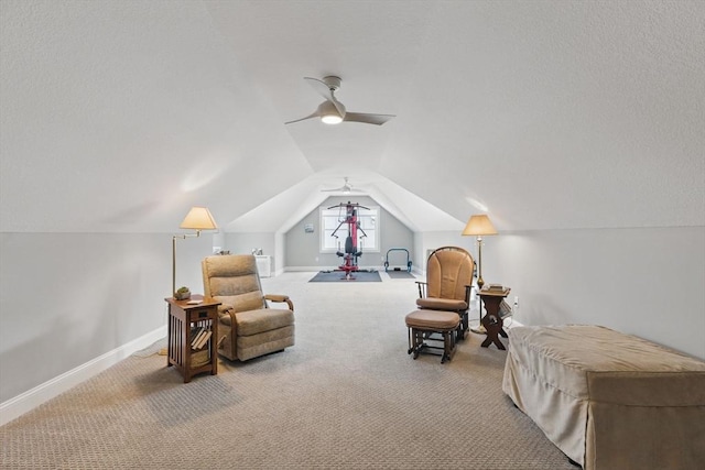 living area featuring lofted ceiling, light carpet, a textured ceiling, and baseboards