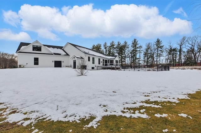 view of snow covered back of property