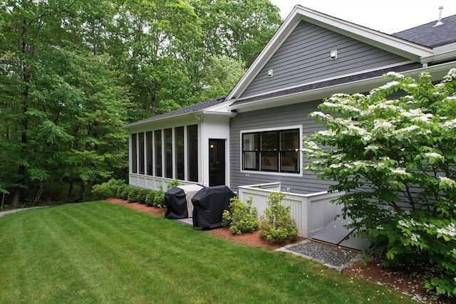 20 Davenport Ln Unit 20, Hopkinton, MA 01748 - view of home's exterior featuring a sunroom, a lawn, and a shingled roof