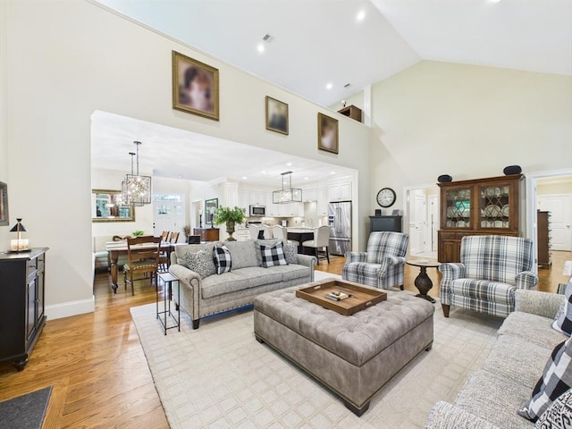 20 Davenport Ln Unit 20, Hopkinton, MA 01748 - living room with light wood-type flooring, a chandelier, high vaulted ceiling, and baseboards