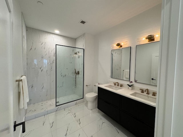 bathroom with vanity, toilet, and a tile shower