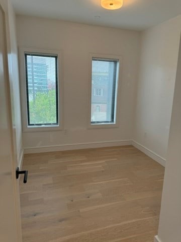 spare room with light wood-type flooring