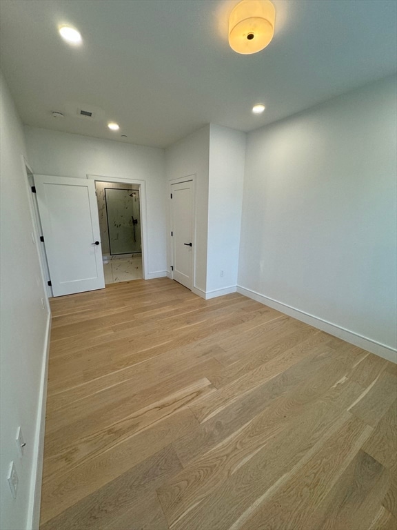 spare room featuring light hardwood / wood-style flooring