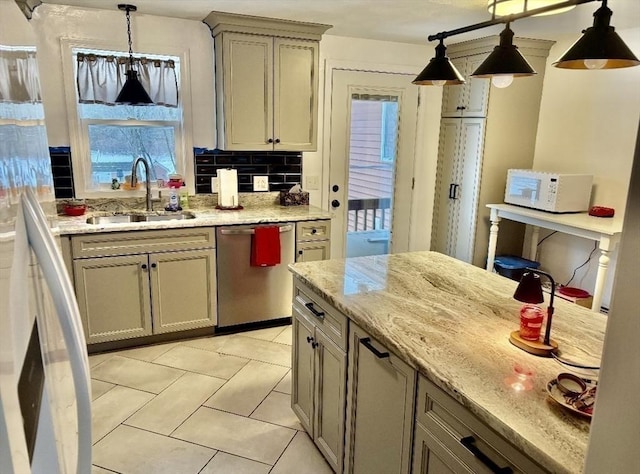 kitchen featuring stainless steel dishwasher, white microwave, light stone counters, decorative backsplash, and a sink