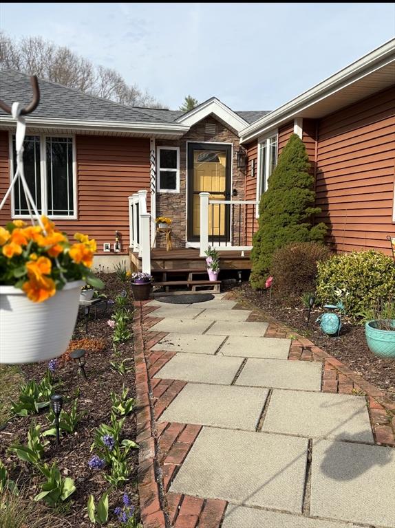 exterior space with a shingled roof