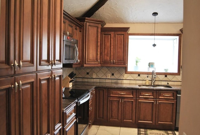 kitchen with range with electric cooktop, pendant lighting, stainless steel microwave, a sink, and backsplash