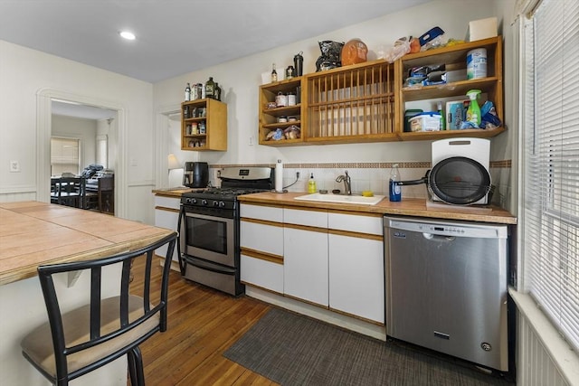 35 Ibbetson, Somerville, MA 02143 - kitchen featuring appliances with stainless steel finishes, a sink, open shelves, white cabinetry, and dark wood finished floors