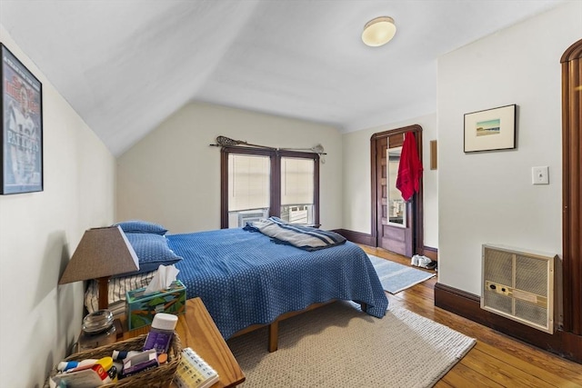 35 Ibbetson, Somerville, MA 02143 - bedroom with hardwood / wood-style floors, vaulted ceiling, heating unit, and baseboards