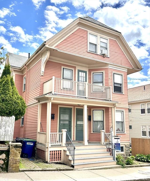 35 Ibbetson, Somerville, MA 02143 - victorian home featuring a balcony, a porch, and cooling unit
