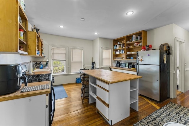 35 Ibbetson, Somerville, MA 02143 - kitchen with open shelves, stainless steel appliances, dark wood-style flooring, tile countertops, and a sink