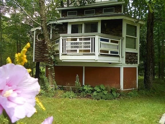 rear view of house with a lawn