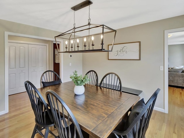 119 Esten Rd, Stoughton, MA 02072 - dining room featuring light wood-type flooring, baseboards, and a chandelier