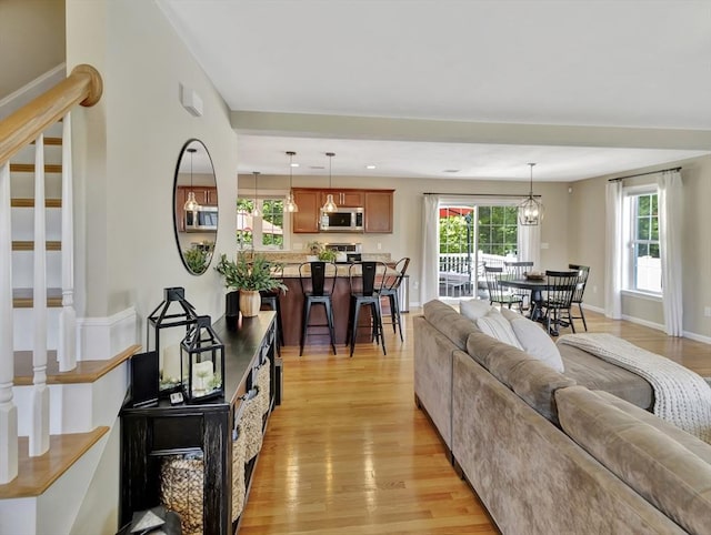 119 Esten Rd, Stoughton, MA 02072 - living room featuring stairs, light wood-type flooring, and baseboards