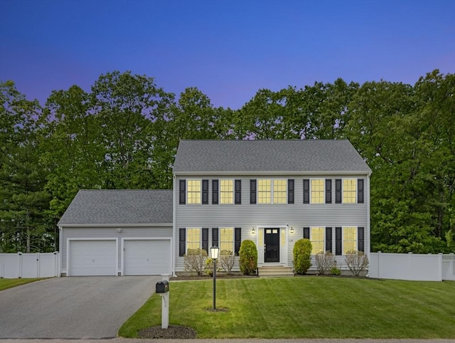 119 Esten Rd, Stoughton, MA 02072 - colonial-style house featuring an attached garage and asphalt driveway
