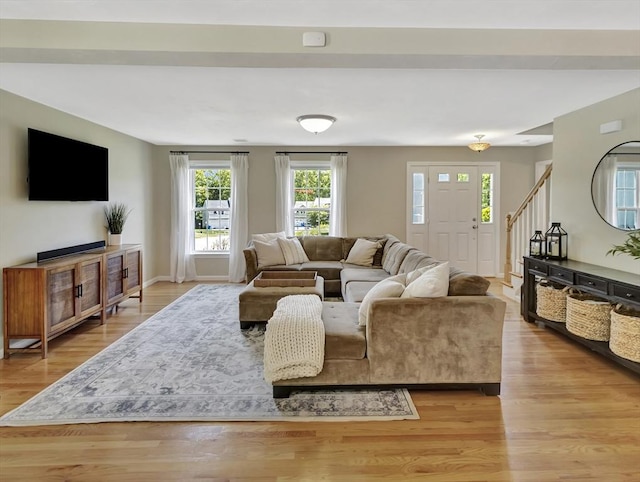 119 Esten Rd, Stoughton, MA 02072 - living room with stairs, light wood-type flooring, and baseboards