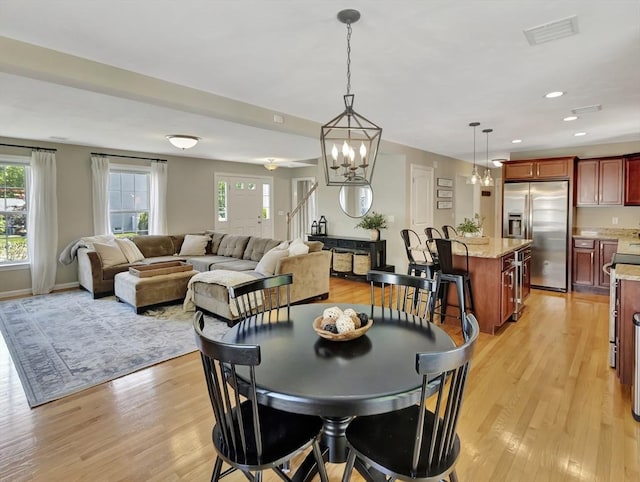 119 Esten Rd, Stoughton, MA 02072 - dining room with healthy amount of natural light, light wood-style floors, stairway, a chandelier, and recessed lighting